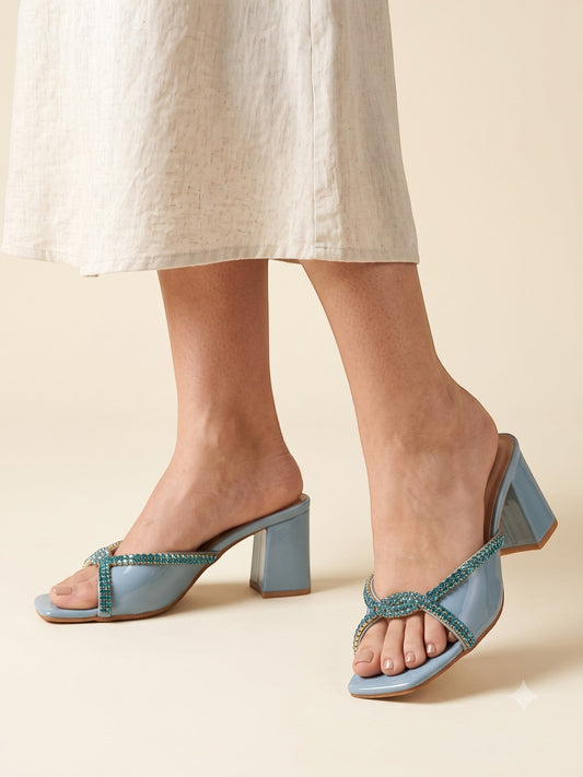 Runway Stores blue synthetic block heels with a T-shaped open toe and embellished straps worn with a linen skirt.