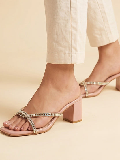Runway Stores blush pink block heel slide sandals with crystal-embellished crisscross straps and square toe design.