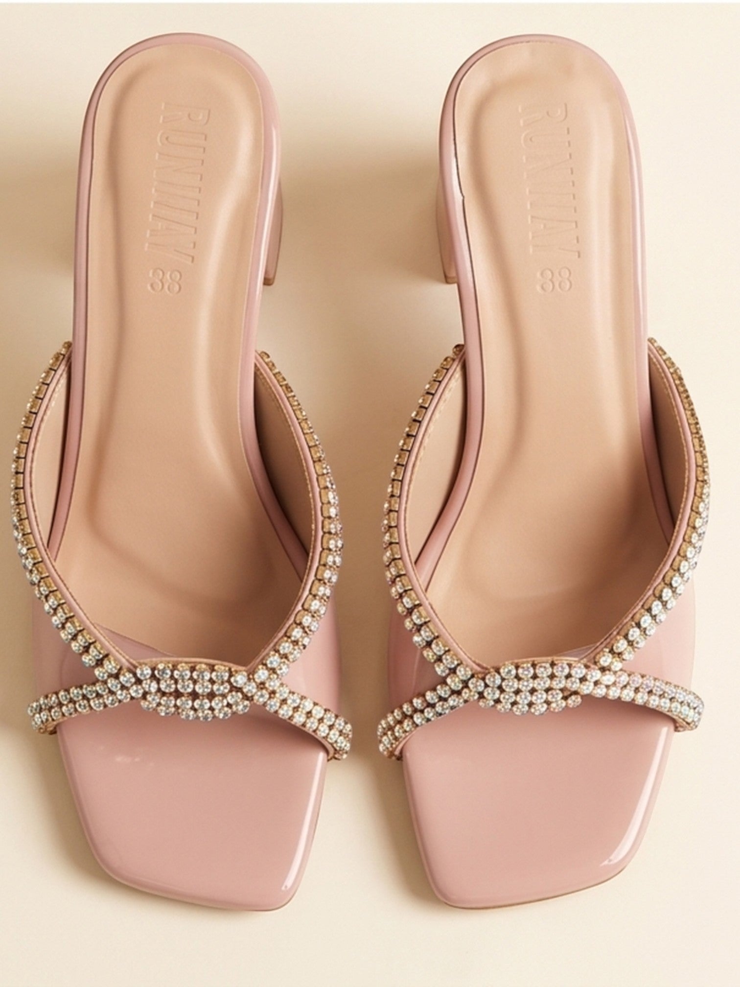 Runway Stores blush pink slide sandals with crystal embellished crisscross straps and a comfortable block heel.