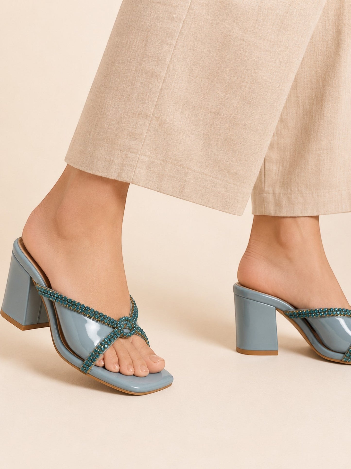 Runway Stores Diana blue block heels with T-shaped open toe and embellished straps worn with beige trousers